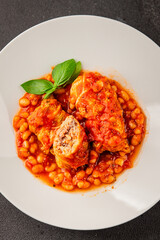 Stuffed cabbage tomato sauce with beans meat, cabbage, fresh delicious gourmet food background on the table rustic food top view copy space
