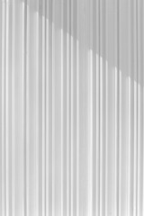 Obraz premium Decorative concrete vertical groove pattern of a building facade. Grooved White cement background