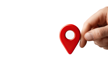 A hand holds a small, red, glossy map marker