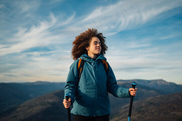 Hiker breathing fresh air on mountain top at sunset