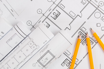 Pencils and paper ?ngineering house drawings and blueprints.
