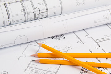Pencils and paper ?ngineering house drawings and blueprints.