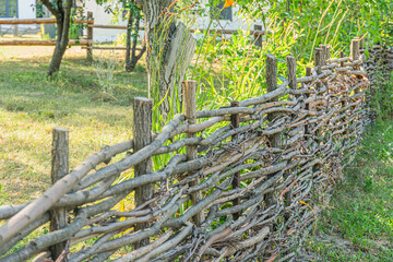 Rustic wooden fence, earth tones, daytime lighting, greenery in the background, subtle sky hint, off-center perspective, dynamic line composition, realistic photograph style, grainy image quality, tr