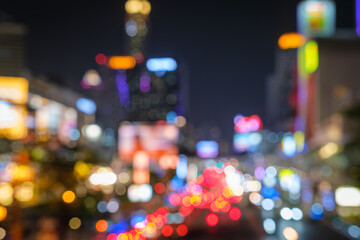 Abstract blurred background cityscape of Krung Thep Maha Nakhon (Bangkok) on night scene with multicolour bokeh from neon light on building