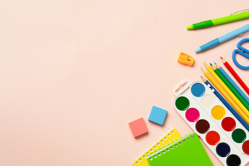 School supplies on colored background.