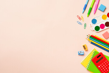School supplies on colored background.