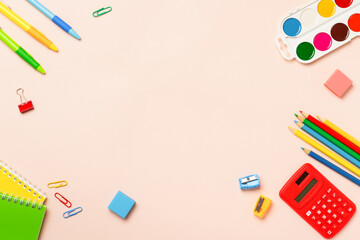 School supplies on colored background.