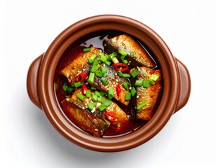 caramelized fish in clay pot, garnished with green onions and chilies