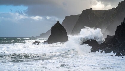 Tempestuous Ocean Fury: Massive White Waves Explode Against Dark, Jagged Volcanic Cliffs.