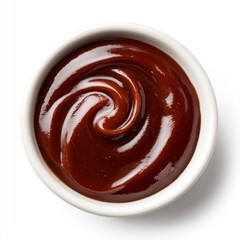 A top-down view of a bowl of barbecue sauce, showcasing its rich color and tempting texture. A swirl of dark, glossy barbecue sauce fills a small, white bowl