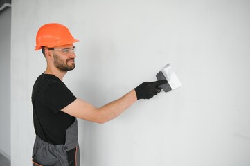 Male workers doing interior renovation in apartment.