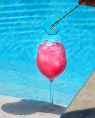 Cocktail with a swimming pool in the background
