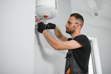 Professional plumber servicing a boiler