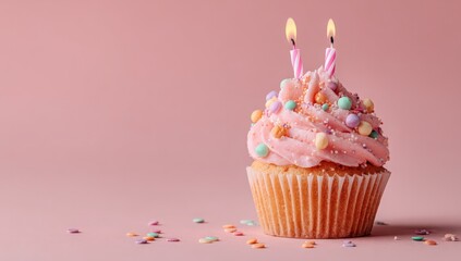 Cupcake Celebration: A delectable cupcake adorned with pink frosting, colorful sprinkles, and two lit candles sits gracefully. This represents happiness and sweet memories!