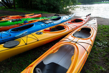Double seats kayaks and paddles are prepared on the shore for a travel, tourism, and recreation...