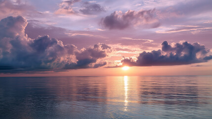 Peaceful sunset over the ocean with soft pink-gray sky