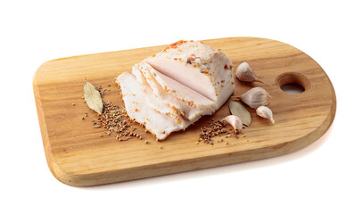 Salted lard with spices on a cutting board.