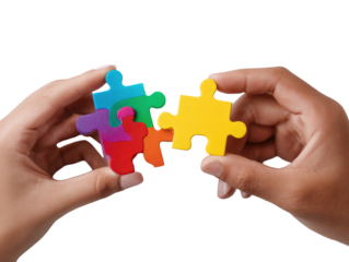Two hands hold colorful puzzle pieces, nearly joined