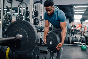 Bodybuilder lifting weights in modern gym for intense workout