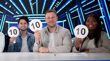 Happy Judges Sitting With Scorecards - Powered by Adobe