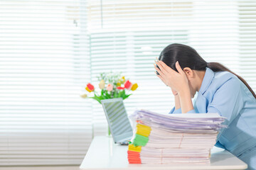 Businesswoman stressed searching for documents to check accounts and analyze business plan from a...