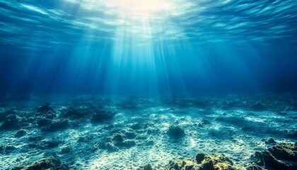 The ocean is very deep and blue. The sun is shining on the water. There are no people or animals in the water