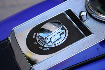 Motorcycle ignition switch. Close up of chrome motorcycle ignition switch with words 