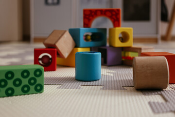 Colorful wooden educational blocks on play mat
