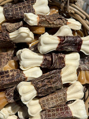 Delicious bone shaped dog treats wrapped in dried meat in a basket