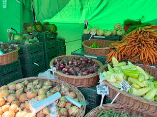 Fresh vegetables displayed at farmers market stall enticing shoppers