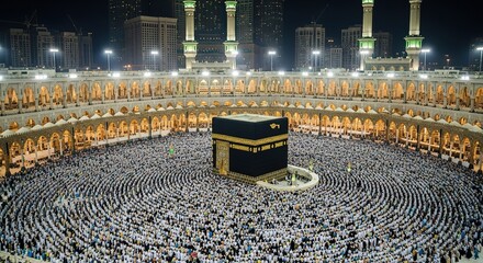 Nighttime aerial view of the Kaaba in Mecca, surrounded by a vast crowd of pilgrims during Hajj.