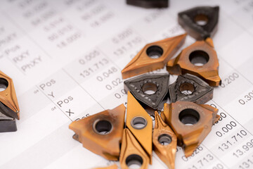 Detailed view of precision cutting tools on a technical sheet in a workshop