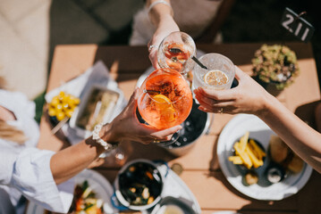 A group of people are celebrating with drinks and food