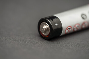 Battery lying on a dark surface ready for use in electronic devices or toys for various applications