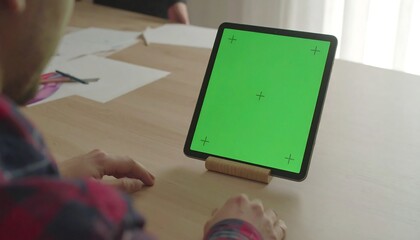 Man Using a Tablet With a Green Screen on a Desk, Tablet Mockup With Tracking Markers for Chroma Key Effects