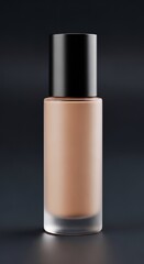 Closeup studio shot of a foundation bottle with black cap on a dark background for beauty concept