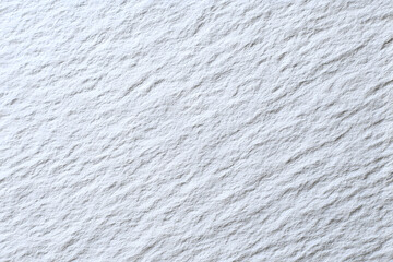 Close up of a textured white surface with subtle shadows