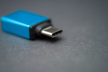 USB-C adapter rests on a dark surface while showcasing its sleek design and functionality for...