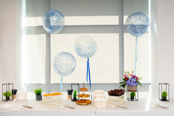 Elegant dessert table with balloons