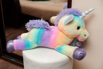 Colorful plush unicorn on seat
