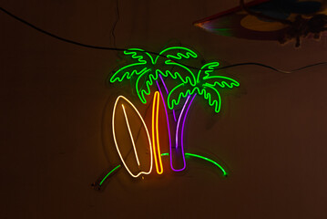 Neon palm trees and surfboard sign