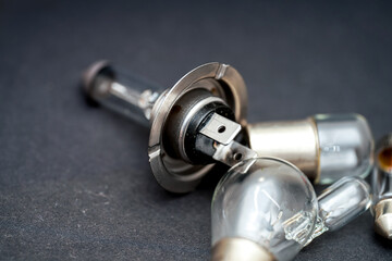 Close-up view of disassembled components for car headlights on a dark background