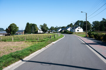 Asphalt road through the fields in Libramont, Province de Luxembourg, Belgium