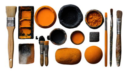 A flat lay arrangement of various shades of orange and black pigments, and paintbrushes