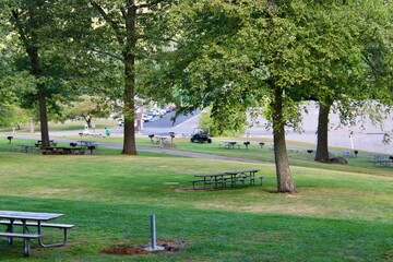Serene Park Setting With Lush Greenery and Picnic Tables in a Tranquil Outdoor Environment
