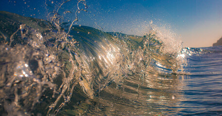 Inside curling ocean wave with sunlight reflections
Close-up view inside a curling ocean wave with...