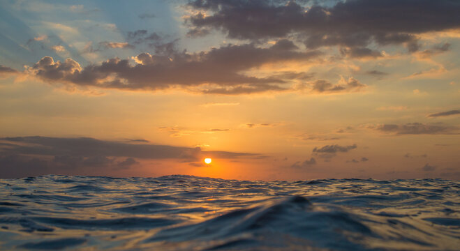 Sunset in the oceSurfing culture Sunset at ocean in Bali