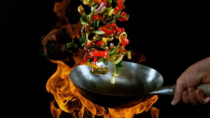 Freeze Motion of Flying Asian Wok Ingredients with Fire Flames