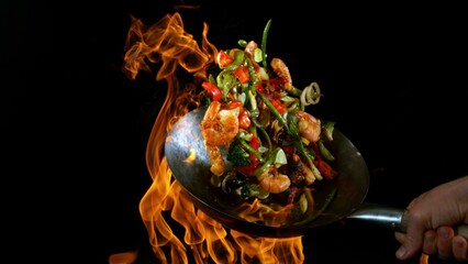 Freeze Motion of Flying Asian Wok Ingredients with Fire Flames