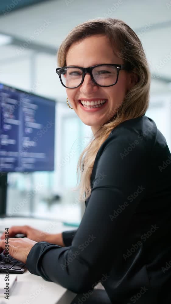 Aufkleber happy female programmer working on multiple screens